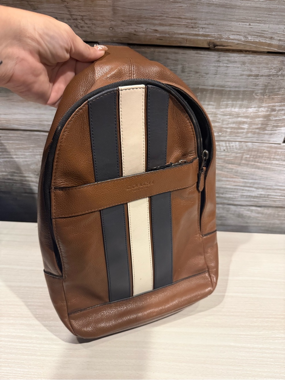 Coach Brown Leather Sling Backpack with Black and Cream Center Stripes